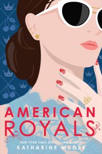 The cover of American Royals by Katharine McGee, showing a young woman in sunglasses and a blue lace top with red and white striped/starred nail polish.